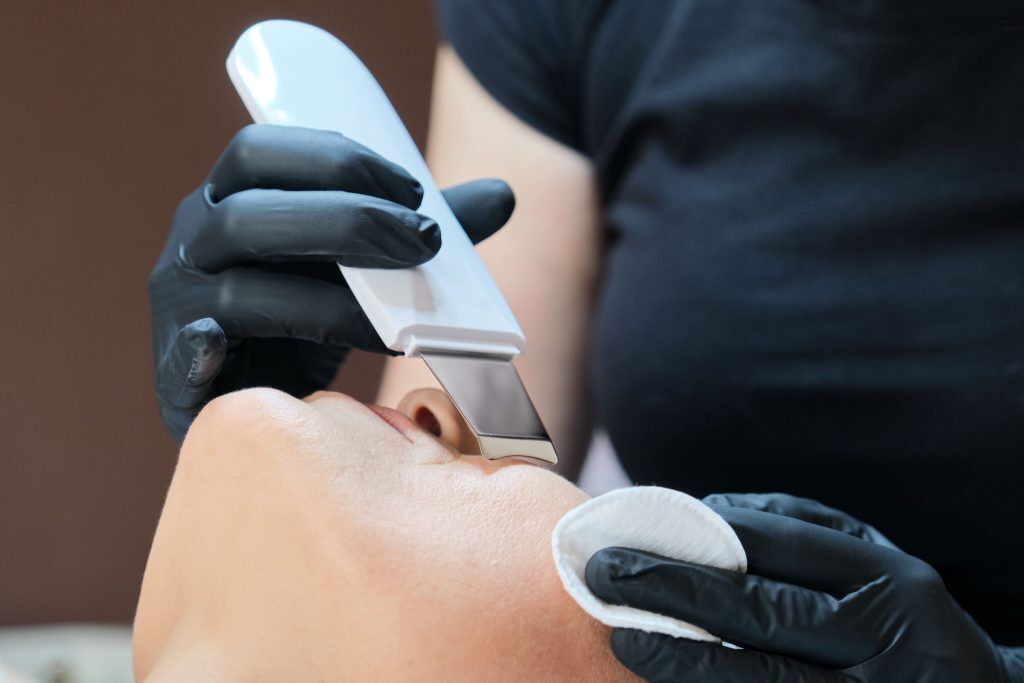 Aesthetician performing professional dermaplaning treatment at Forte Faces in Conshohocken to remove dead skin cells and peach fuzz for an instantly brighter complexion.